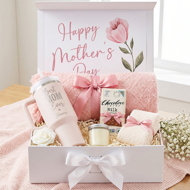Pink personalized mom gift box for birthday, Mother's Day Gifts, and Christmas. Comes with a custom 40oz tumbler, chocolate bar, fuzzy socks, throw blanket, and scented candle.