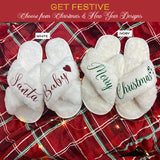 Santa Baby Christmas Slippers with other festive designs.  These are criss-cross style fluffy slippers for women.  Great gift for her during the holidays. all SKUs