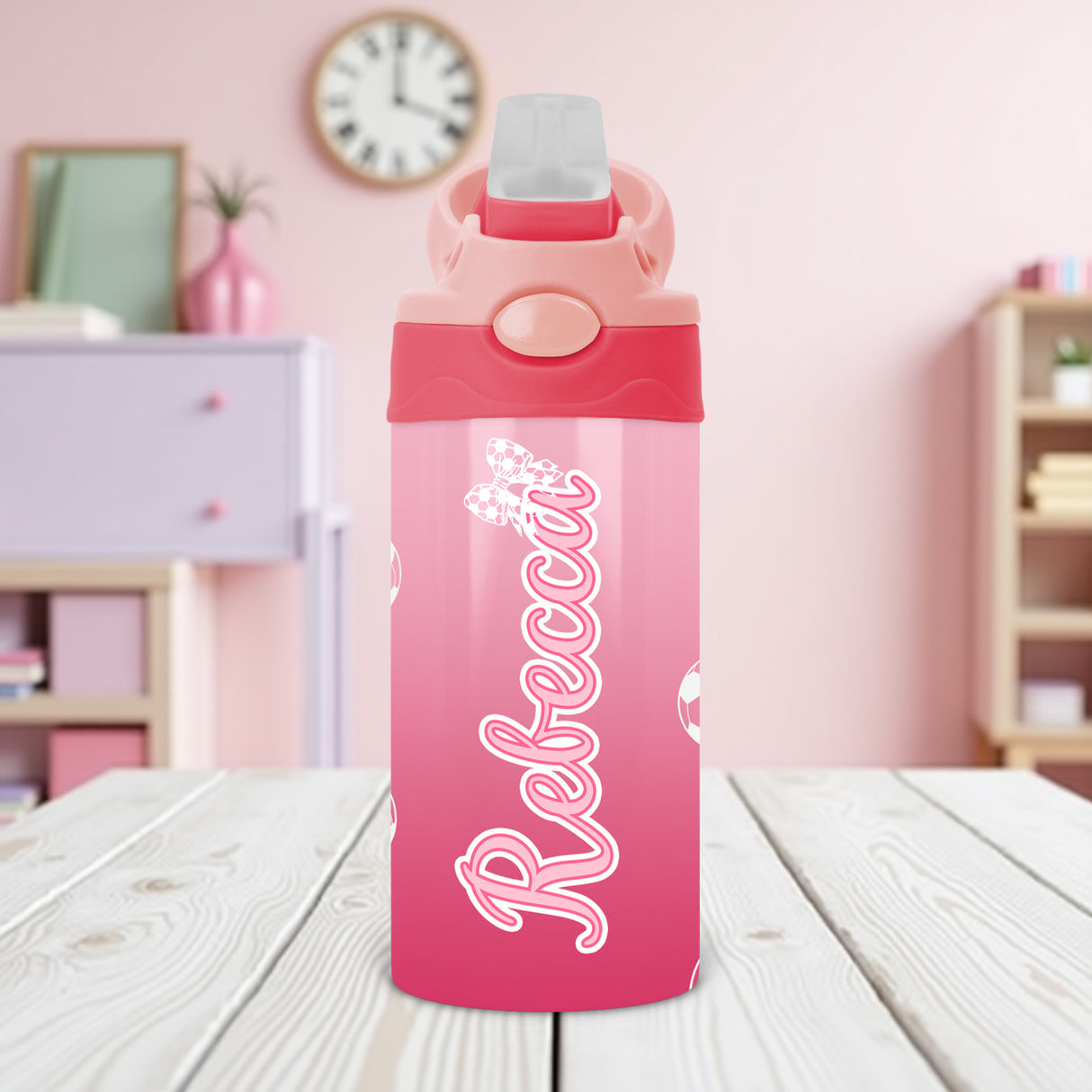Kids custom water bottle featuring pink soccer design and name personalization for youth athletes.