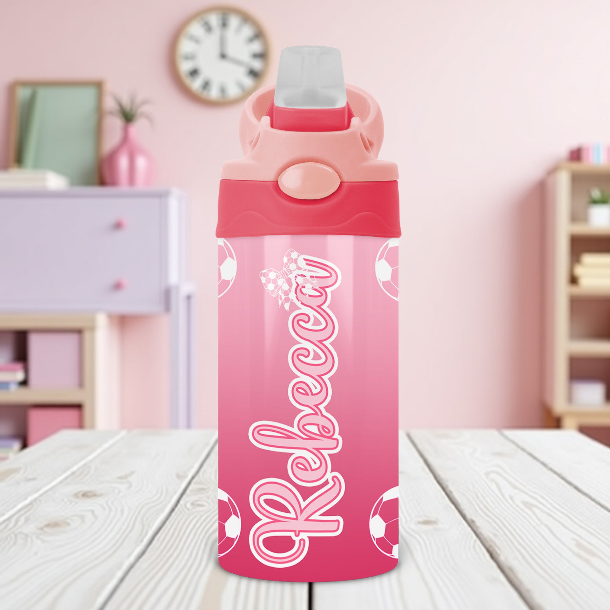Kids custom water bottle featuring pink soccer design and name personalization for youth athletes.