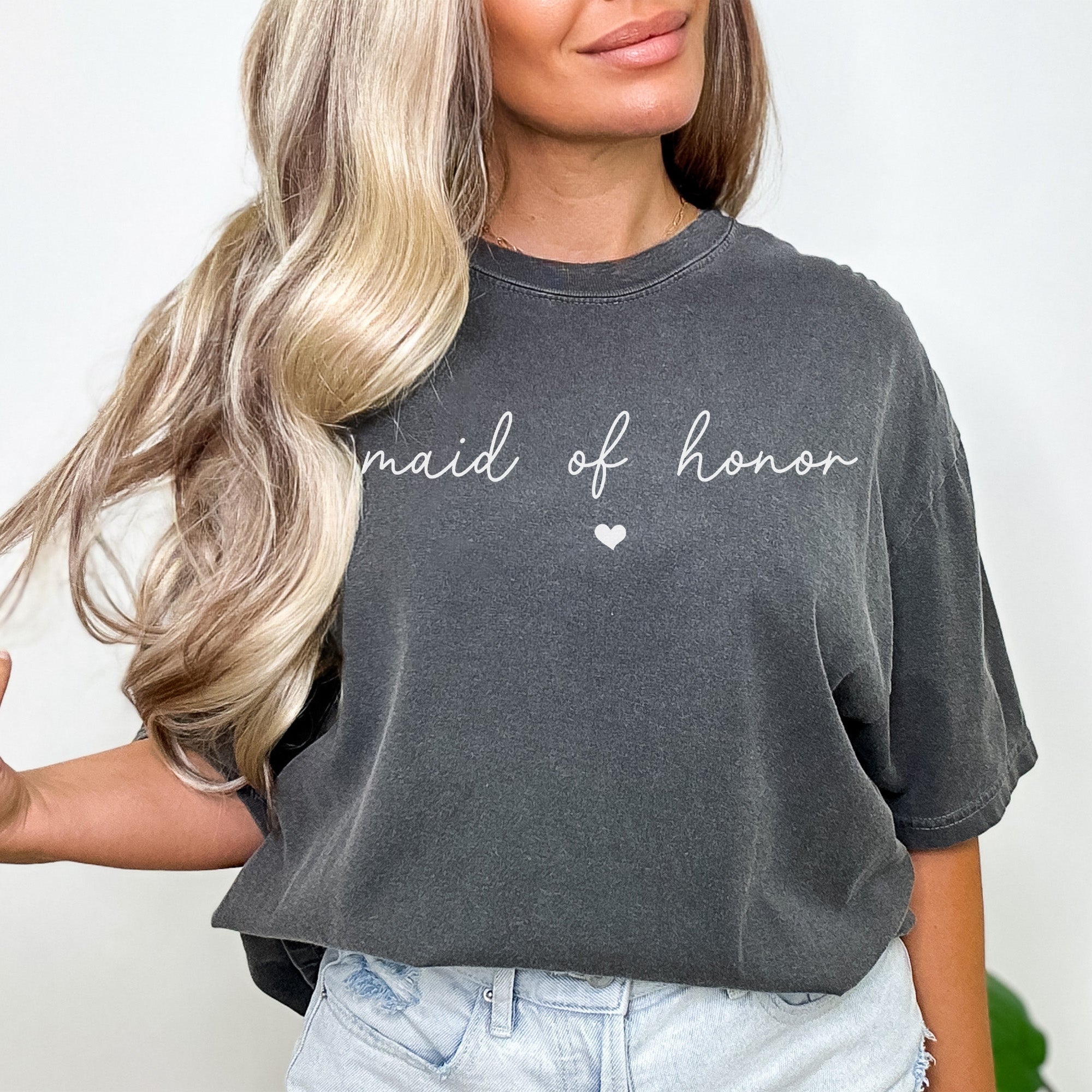 Maid of honor wearing a personalized Comfort Colors sweatshirt with custom text. Perfect for bridal party photos, bachelorette weekends, and bridesmaid gift boxes. This shirt is a cute maid of honor gift.