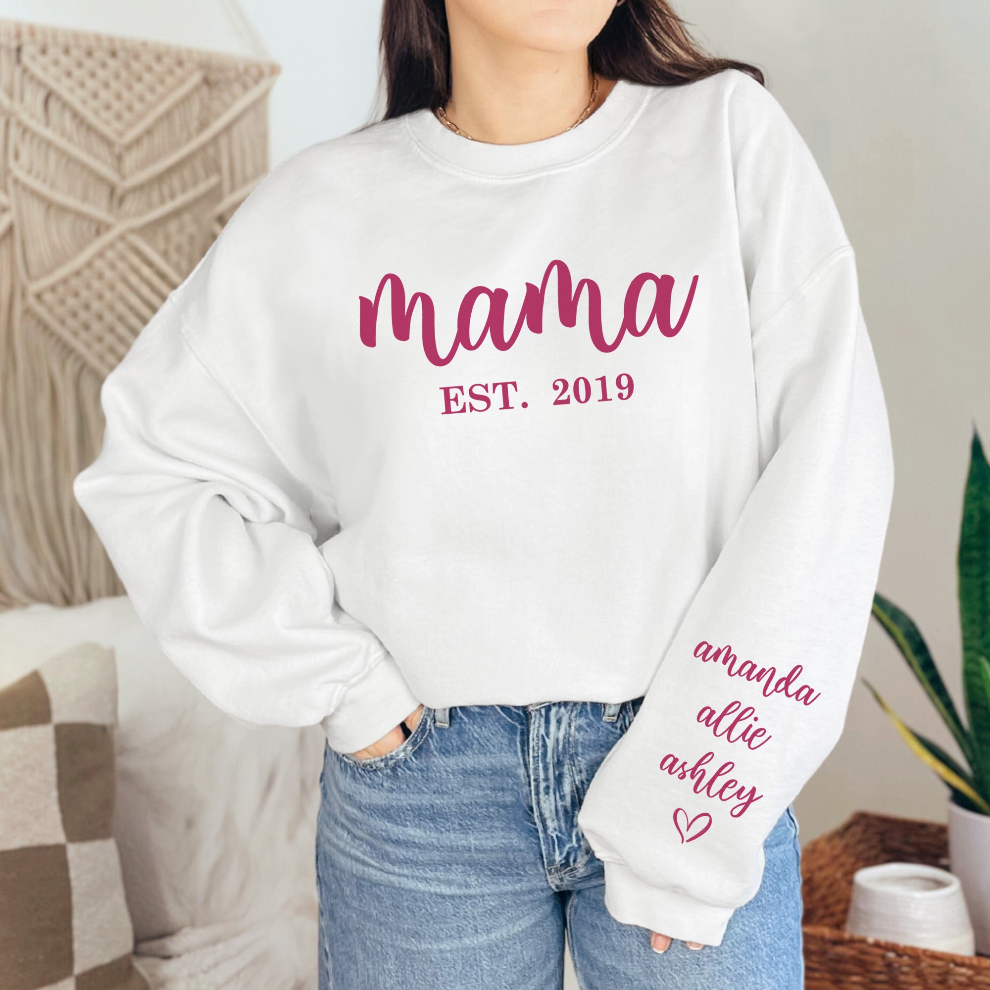Close up of a woman wearing a personalized Mama sweatshirt, with children's names running down the sleeve. Sweet mothers day gift, custom name sweatshirts for mom. 