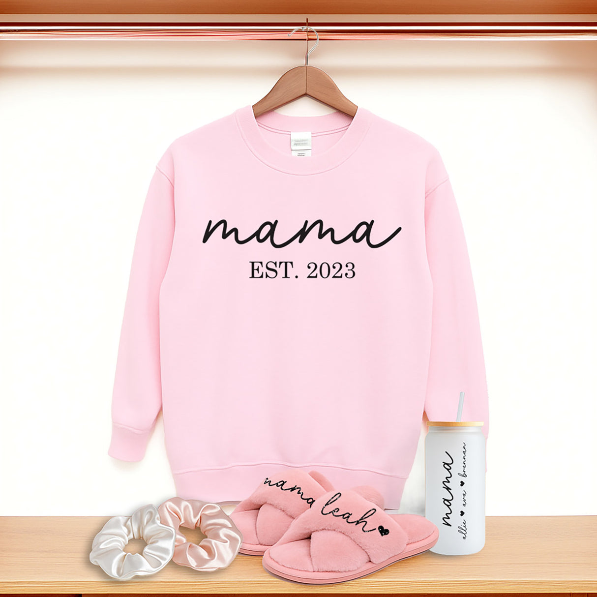 Cute gift bundle for mom with custom Mama sweatshirt, fluffy slippers, Libbey glass coffee can, and scrunchies. The best gift basket for mom. Personalized birthday gift for moms.