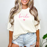 Bride wearing a custom Comfort Colors sweatshirt with Bride text, ideal for bachelorette parties or morning-of wedding photos. Cute and simple bride to be gift.
