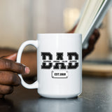 Father drinking from personalized coffee mug with kids names, perfect gift idea for him on Father’s Day, birthday, or new dad celebration.