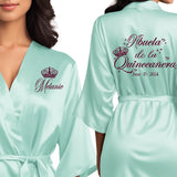 Front and back personalized satin quinceanera robes at knee length. Abuela de la quinceanera getting ready robes.