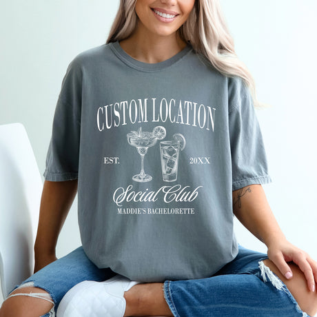 Custom Comfort Colors bachelorette party shirts with personalized location and Social Club design, perfect matching shirts for bride and bridesmaids.
