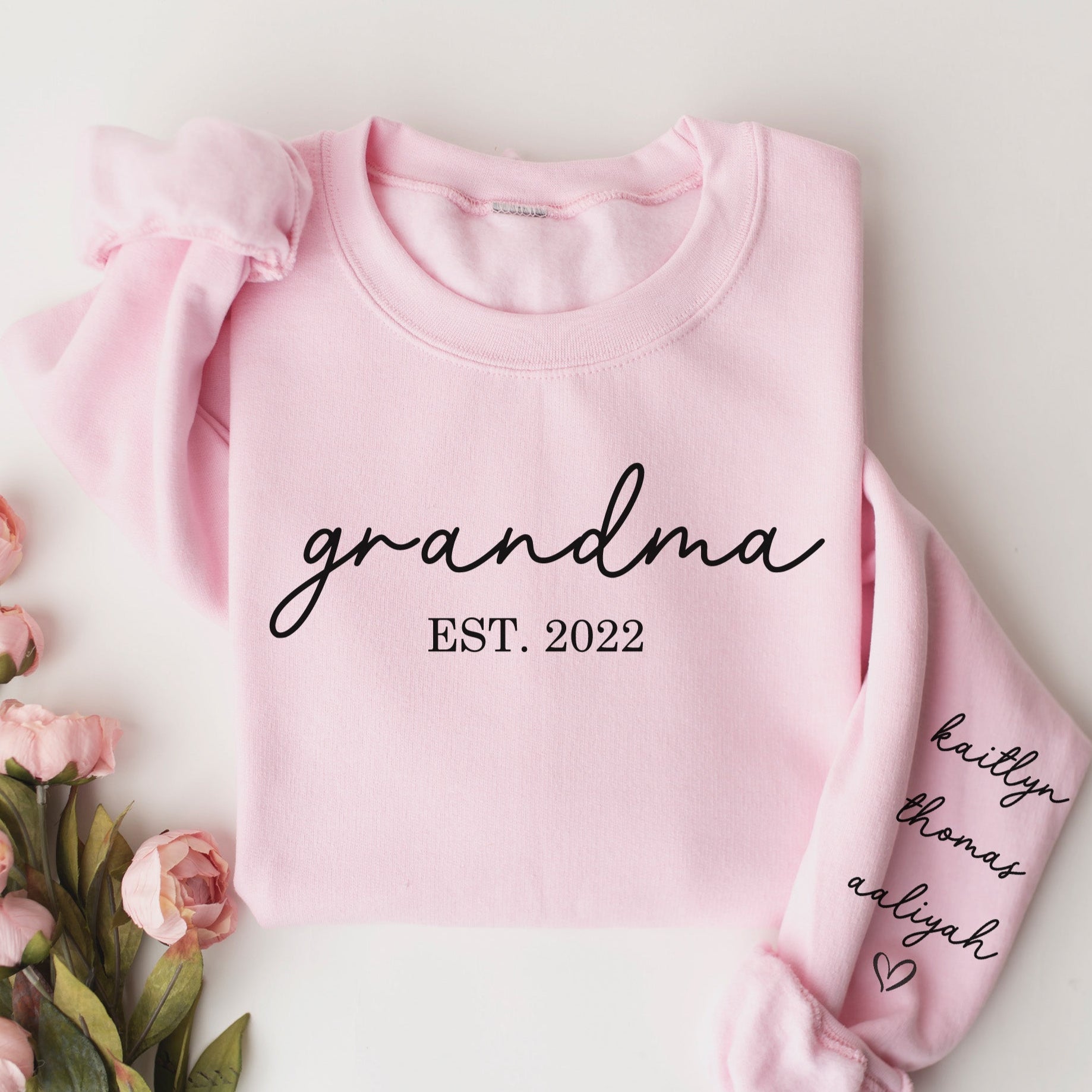 Custom sweatshirt with grandkids’ names printed on sleeve, unique Mother’s Day gift for grandma.