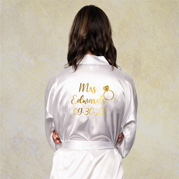 Backview of custom bride robe showing future last name, wedding date and ring design with gold foil HTV. all SKUs