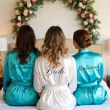 Beautiful white and turquoise blue bride and bridesmaid robes for getting ready. Personalized bridesmaid gifts for the wedding.