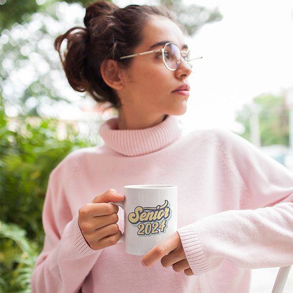 Woman holding 11oz Senior 2024 graduation mug. A great graduation gift for him or her. allSKUs.