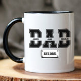 Unique Father’s Day gift ideas for dad. Coffee mug for dad with kids names printed in bold varsity lettering, available in 11oz or 15oz sizes.