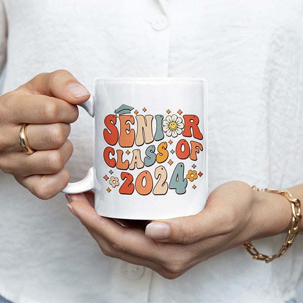 Woman holding senior class of 2024 coffee mug. The perfect graduation gift idea for her. All SKUs. 