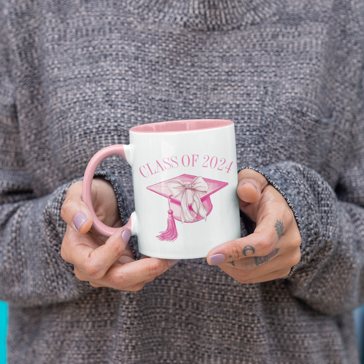 Woman holding a 2024 graduation mug for the senior class of 2024. All SKUs. 