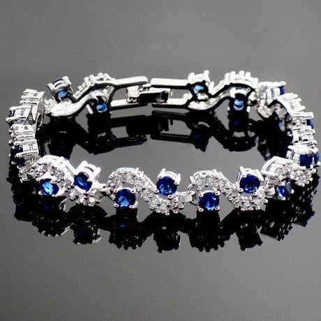 Stylish and hypoallergenic blue sapphire bracelet for women, showcasing sparkling Swarovski elements on a sleek link chain.