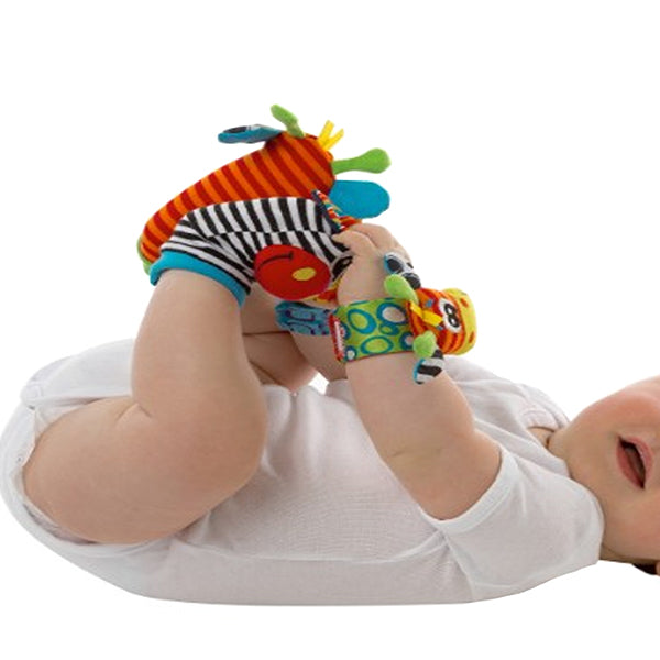 baby playing with hand foot finder rattles