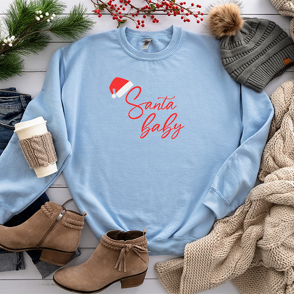 Flat lay photo of light blue sweatshirt with Santa Baby design.  Christmas sweatshirt for women in Small to 5XL sizes.  all SKUs