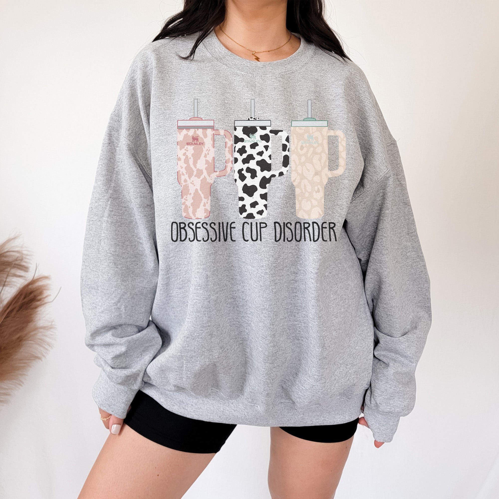 https://giftsareblue.com/cdn/shop/products/obsessive-cup-disorder-heather-gray-sweatshirt-model_wm.jpg?v=1695355574