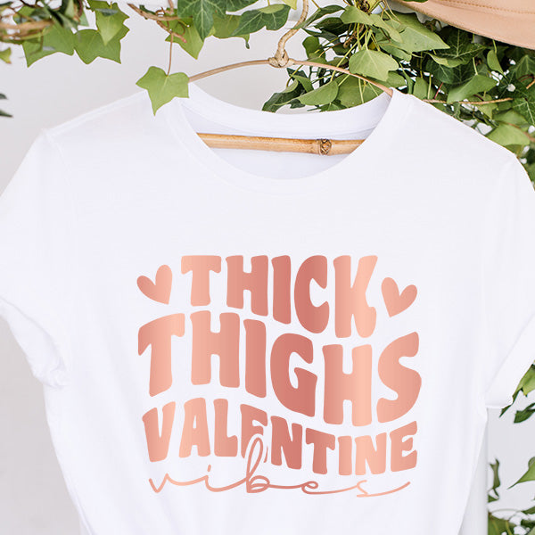 Shop our Thick Thighs Valentine Vibes tops that are available as a tshirt, crop top, crop hoodie, long sleeve tee, sweatshirt or hoodie.  We offer several colors and sizes from XS to 6XL. all SKUs