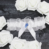 white wedding garter set with flower charm lifestyle
