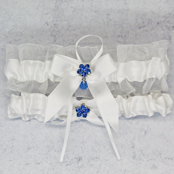 white wedding garter set with flower charm main