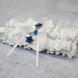 white wedding garter set with flower charm diagonal view