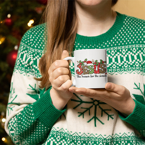 Woman holding holiday mug with Christian message.